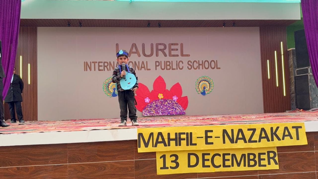 A young student speaking at the mic during Mahfil-e-Nazakat